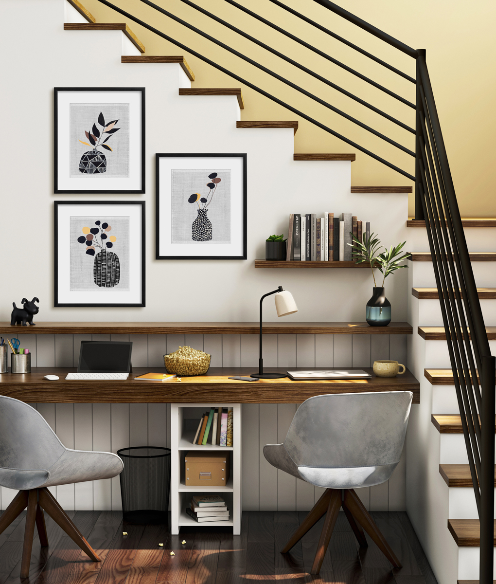 image of office in the nook under the stairs with three small pieces of art
