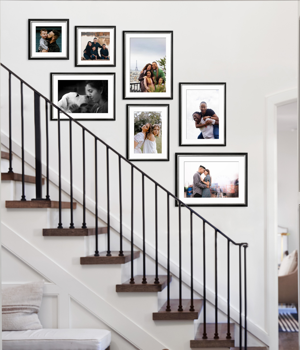Family photo gallery wall hung above a staircase