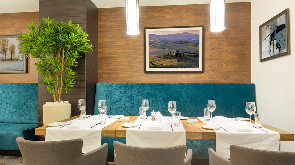 Framed abstract art and photo prints in a restaurant. Dining area décor to create a pleasant experience for foodies and diners.